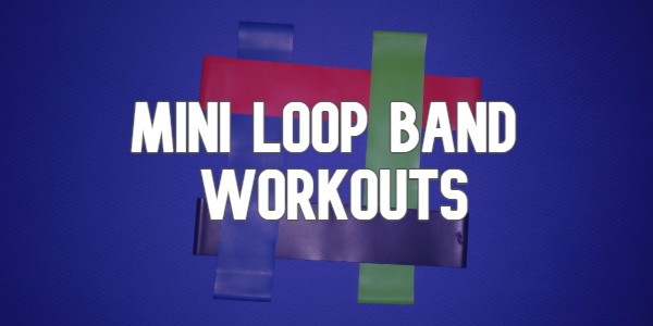 Resistance bands on a yoga mat with text 'Mini Loop Band Workouts'